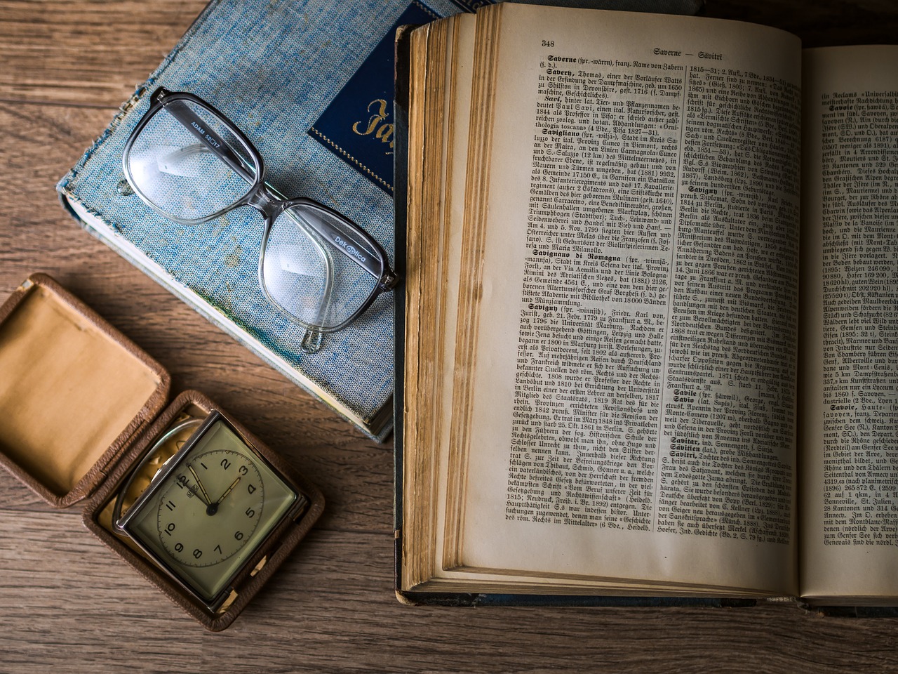 historical book, glasses, clock